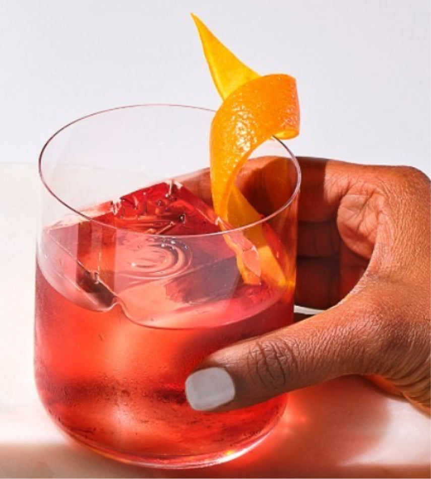 A Negroni with a piece of orange peel in it